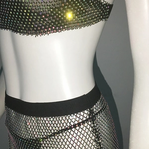 Detail of fishnet mesh bikini skirt with colorful rhinestones on a mannequin