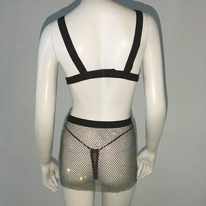 Rear view of black crop top and silver rhinestone fishnet skirt on a white mannequin