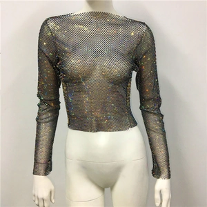 Macro detail of rainbow rhinestones on long sleeve black mesh crop top fabric