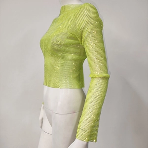 Detail of neon green mesh crop top with sparkling rhinestones and long sleeves
