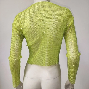 Detail of neon green fishnet top with rhinestone embellishments on the back profile
