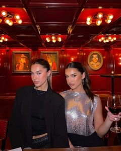Gros plan d'un haut à paillettes argentées avec blazer dans un bar au style rétro