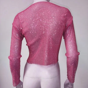 Macro shot of pink mesh fabric with high-density silver rhinestones on a long-sleeve top