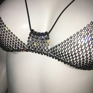 Close-up of black mesh bra with sparkling rhinestones for party and club wear
