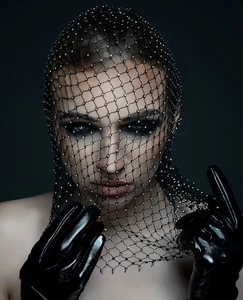 Macro detail of black fishnet headpiece featuring sparkling silver rhinestones and mesh