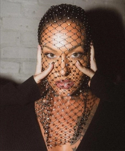 Close-up of black elastic fishnet headpiece with shiny rhinestones for women
