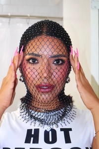 Detail of black elastic fishnet headpiece with sparkling silver rhinestones and tassels