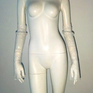 Detailed macro view of silver mesh fingerless long gloves with sparkling rhinestones