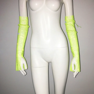 Detailed view of neon yellow fingerless gloves with rhinestones and mesh fabric
