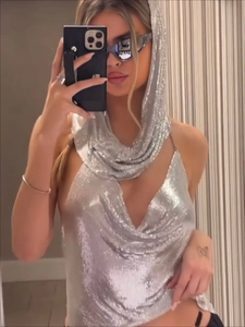 Detail of silver sequin metal mesh hooded crop top with deep V-neckline and reflective finish