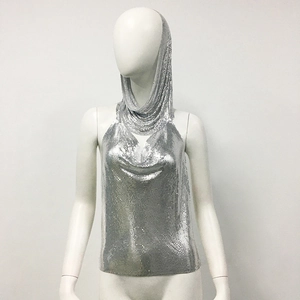 Detail of silver metallic sequin mesh top with a deep V-neck and hood for party wear