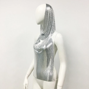 Detailed close-up of shiny silver metal sequin chainmail fabric on a hooded halter top