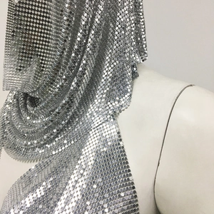 Close-up of silver metal sequin chainmail top with reflective mesh texture detail