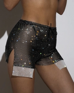 Detail showing shimmering rhinestones on black mesh shorts with high-slit drawstring waist