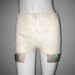 Detailed view of high waisted rhinestone shorts featuring drawstring and metal mesh hem