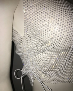 Detail of white beaded mesh top with iridescent rhinestones and adjustable side lacing