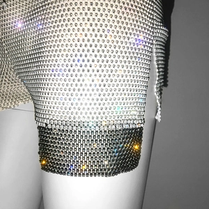 Detailed macro view of the sparkling rhinestone fishnet texture with black and silver contrast