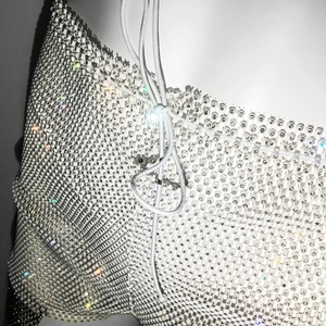 Close-up of white mesh drawstring shorts with detailed rhinestone embellishments