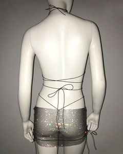 Detail of black mesh mini skirt with colorful rhinestones and wrap tie string design
