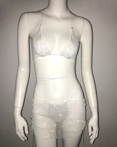 Detail of white rhinestone mesh bikini and mini skirt with lace-up straps on mannequin