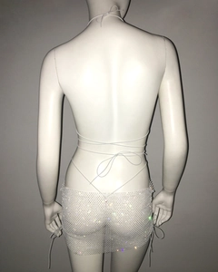 Close-up of white mesh bikini skirt with sparkling colorful rhinestones and tie straps
