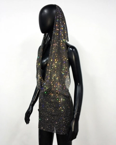 Detail of rhinestone halter top with hood and mini skirt on mesh fabric for party