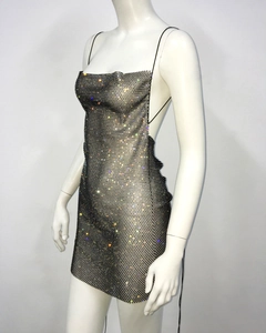 Detail of sequined mesh mini dress featuring a backless design and thin straps for parties