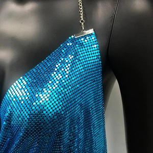 Detail of blue metallic mesh dress with shimmering sequins and silver chain straps