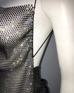 Close-up of sparkling silver rhinestones on black mesh fabric for sexy bodycon dress
