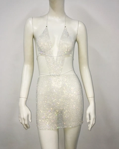 Detail of white two-piece party set featuring shiny rhinestones on mesh fabric
