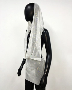 Detail of white rhinestone mesh hood top and mini skirt on a black mannequin for parties