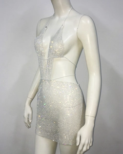 Detail of silver rhinestone dress with sheer mesh texture and shimmering crystals for parties