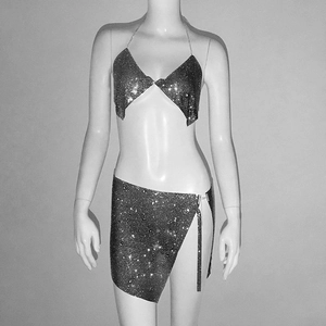 Détail d'un ensemble deux pièces argenté à paillettes avec haut licou et mini-jupe