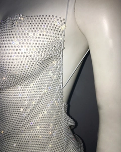 Close-up of sparkling rhinestone mesh detailing and thin shoulder straps on dress