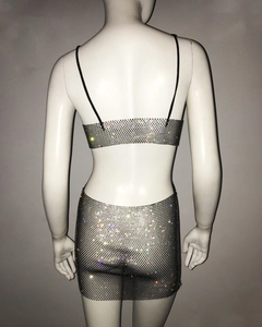 Macro detail of sexy rhinestone fishnet two-piece set featuring shimmering v-neck crystals