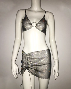 Close-up of metallic mesh crop top and mini skirt set with shimmering rhinestones