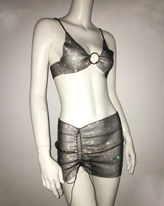 Macro shot of rhinestone fishnet fabric with metal ring detail on the crop top