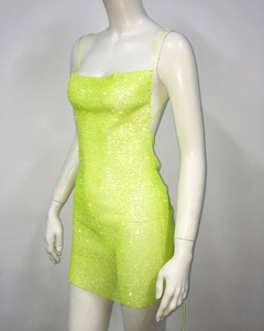 Detailed close-up of fluorescent green rhinestone mini dress with thin straps and sequins