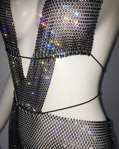 Detail of black mesh dress featuring sparkling rhinestones and delicate tie-up design