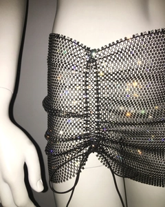Close-up of black mesh mini skirt with multicolor rhinestones and drawstring detail