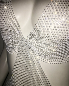 Detail of white sparkling rhinestones on mesh strap dress for nightclub party wear