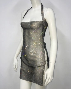 Close-up of sparkling rhinestones on black metal mesh fabric with sheer texture