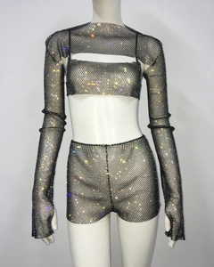 Detail of sparkling rhinestone mesh fabric on a sexy black three-piece party outfit set