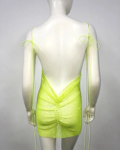 Detail of neon green rhinestone mesh dress featuring backless lace-up and sparkly finish
