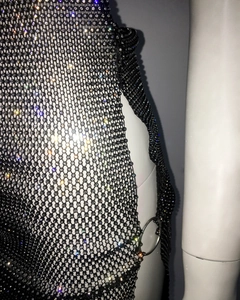 Detailed close-up of a sexy black rhinestone fishnet dress with metal ring connectors