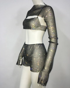 Detail shot of black fishnet three-piece set featuring colorful rhinestones for party wear