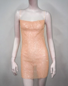 Detail of peach mesh dress featuring sparkling rhinestones and thin shoulder straps
