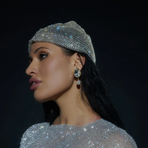 Detail of shimmering rhinestone mesh headpiece with crystal droplet earrings for gala events