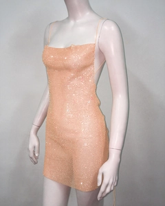 Detailed view of apricot mesh mini dress with shimmering rhinestones and thin straps
