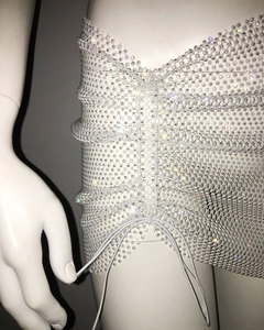 Detail of white rhinestone mesh mini skirt featuring adjustable drawstring for ruching